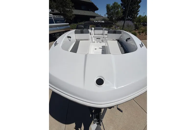 Slide: The Image of 2026 Tahoe T18 boat with spacious seating, displayed outdoors on a sunny day. - 4