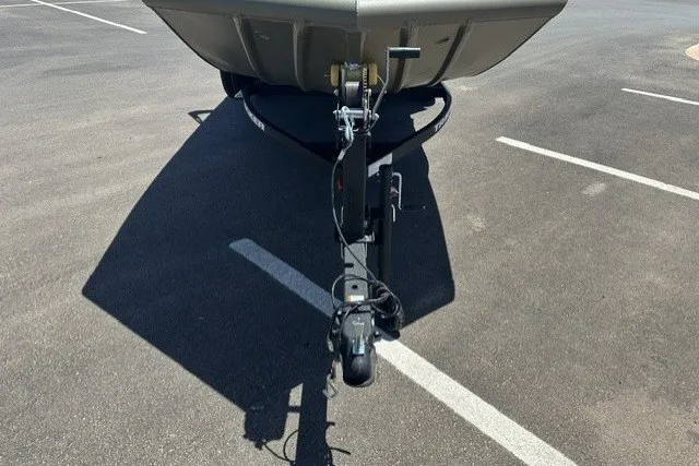 Slide: The Image of 2026 Tracker Grizzly 1756 T Marsh boat trailer hitch in a parking lot. - 18