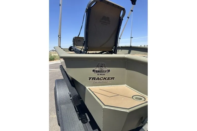 Slide: The Image of 2026 Tracker Grizzly 1756 T Marsh boat, rear view, on trailer, outdoors. - 16