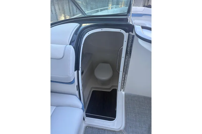 Slide: The Image of 2024 Formula 310 Bowrider OB boat interior with compact marine toilet. - 12