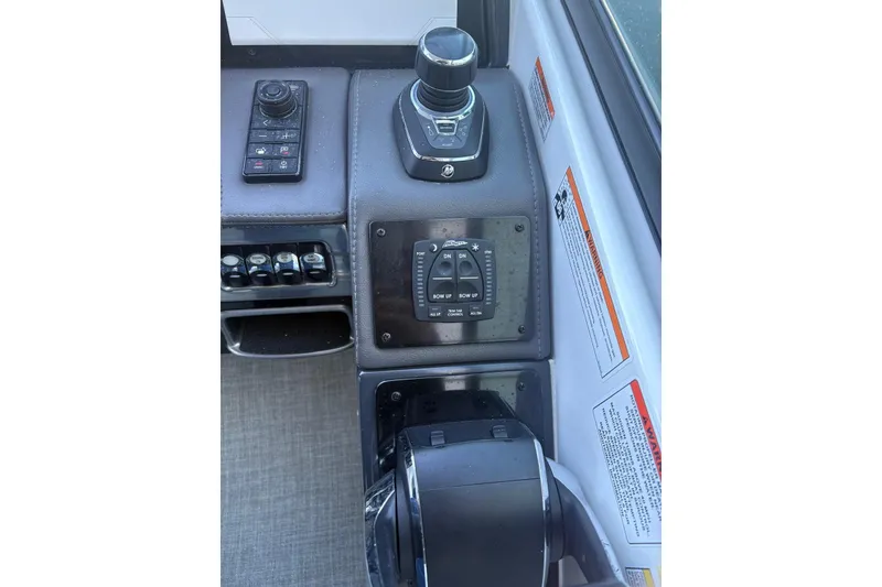 Slide: The Image of 2024 Formula 310 Bowrider OB helm controls with joystick and switches. - 3