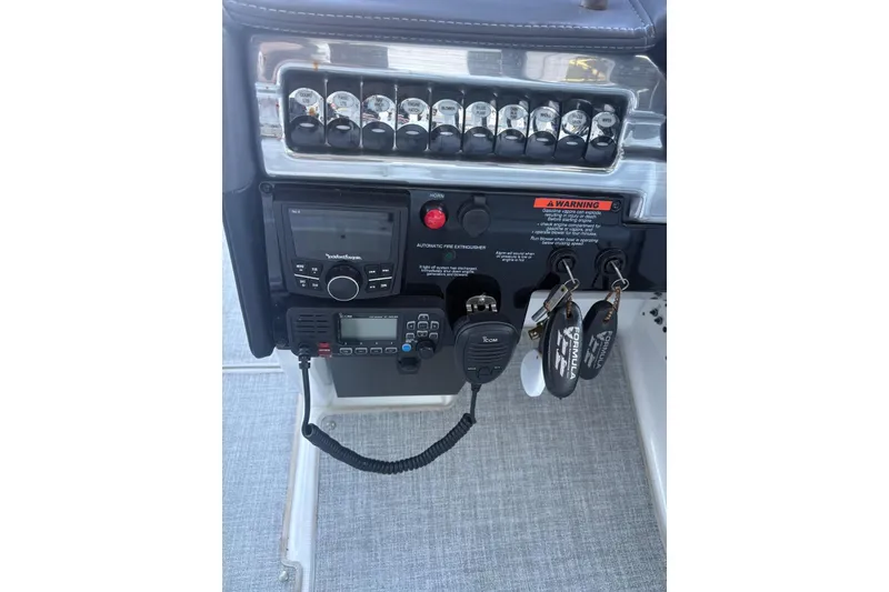 Slide: The Image of 2024 Formula 310 Bowrider OB dashboard with controls and key fobs. - 4