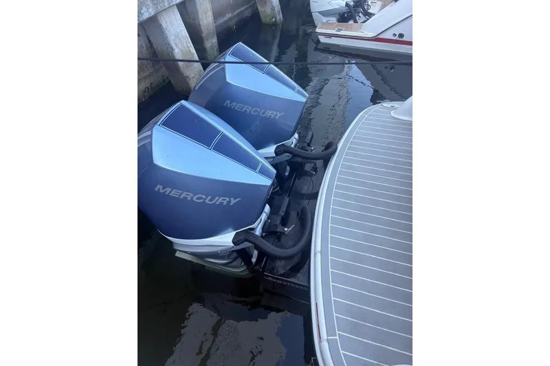 Slide: The Image of 2024 Formula 310 Bowrider OB with dual Mercury outboard engines docked. - 7