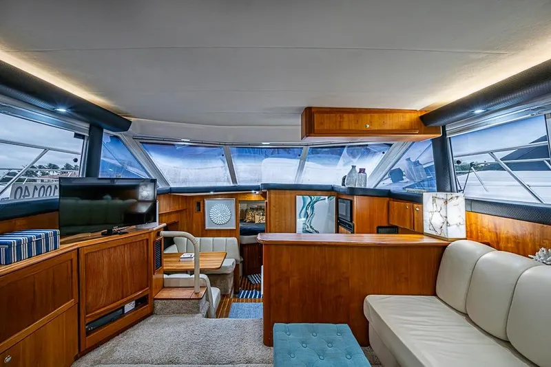 Slide: The Image of Luxurious interior of 2000 Silverton 442 Cockpit Motor Yacht with elegant wood finishes. - 18
