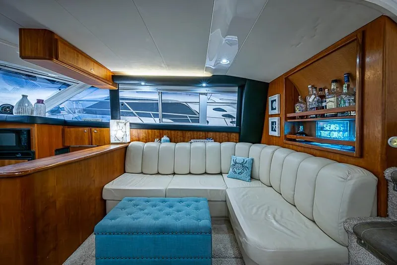 Slide: The Image of Luxurious interior of 2000 Silverton 442 Cockpit Motor Yacht with plush seating and bar area. - 19