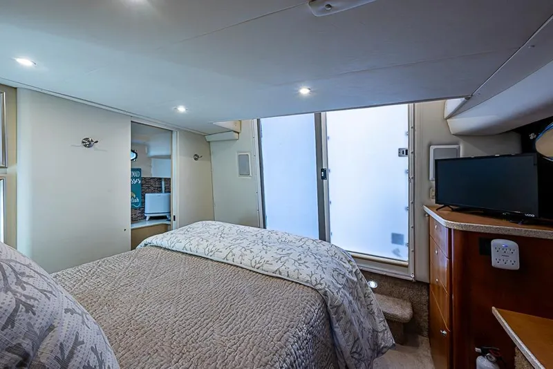 Slide: The Image of Interior of 2000 Silverton 442 Cockpit Motor Yacht bedroom with bed and TV. - 23