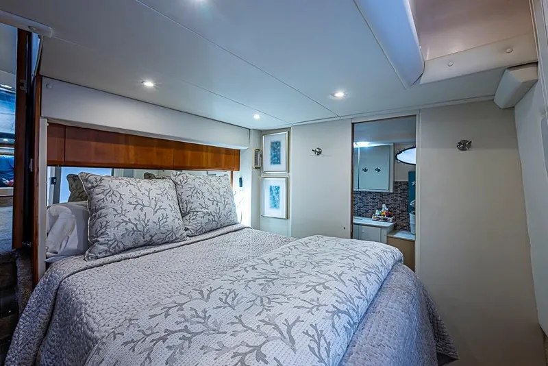 Slide: The Image of Luxurious bedroom interior of 2000 Silverton 442 Cockpit Motor Yacht with elegant bedding. - 24