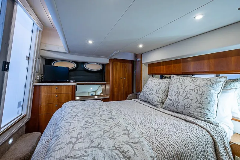 Slide: The Image of Luxurious bedroom interior of 2000 Silverton 442 Cockpit Motor Yacht with elegant bedding. - 25