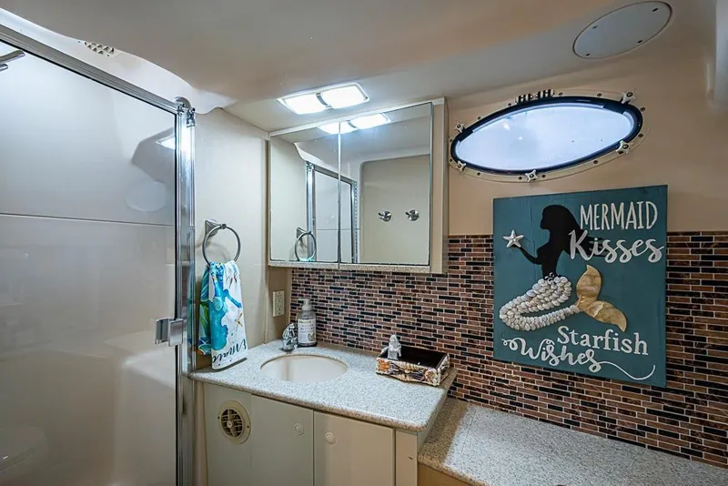 Slide: The Image of Bathroom interior of 2000 Silverton 442 Cockpit Motor Yacht with nautical decor. - 26