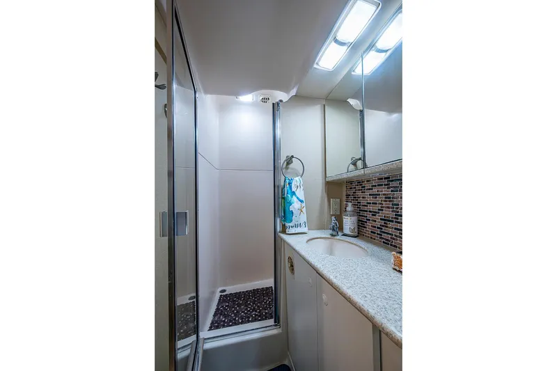 Slide: The Image of Bathroom interior of 2000 Silverton 442 Cockpit Motor Yacht with shower and vanity. - 27