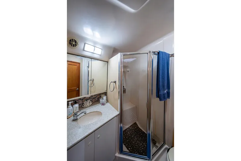 Slide: The Image of Bathroom interior of 2000 Silverton 442 Cockpit Motor Yacht with shower and sink. - 30
