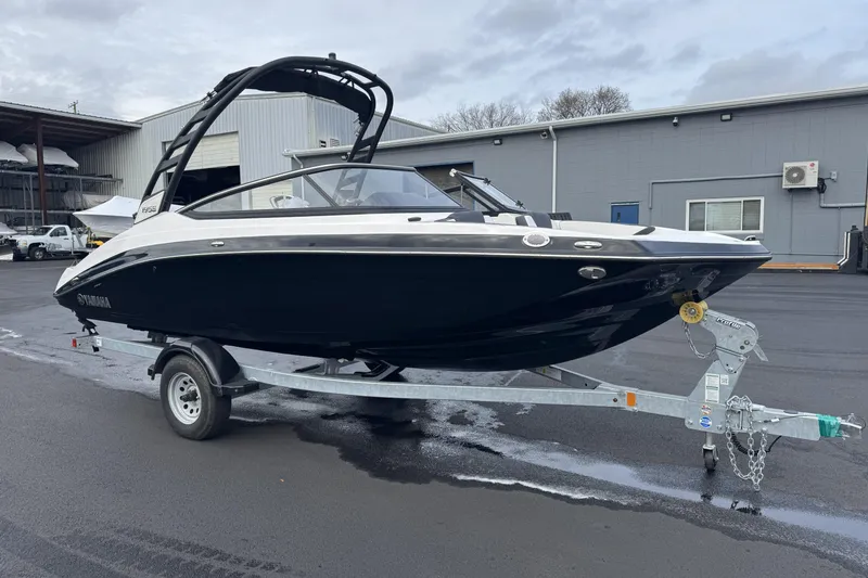 The Image of 2024 Yamaha Boats 195S on trailer, sleek black design, parked outdoors. - 0