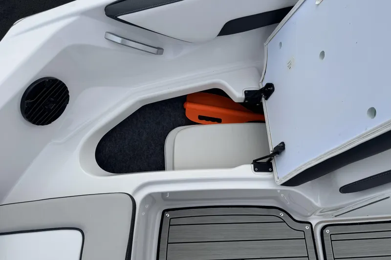 Slide: The Image of 2024 Yamaha Boats 195S storage compartment with open hatch and visible orange item. - 12
