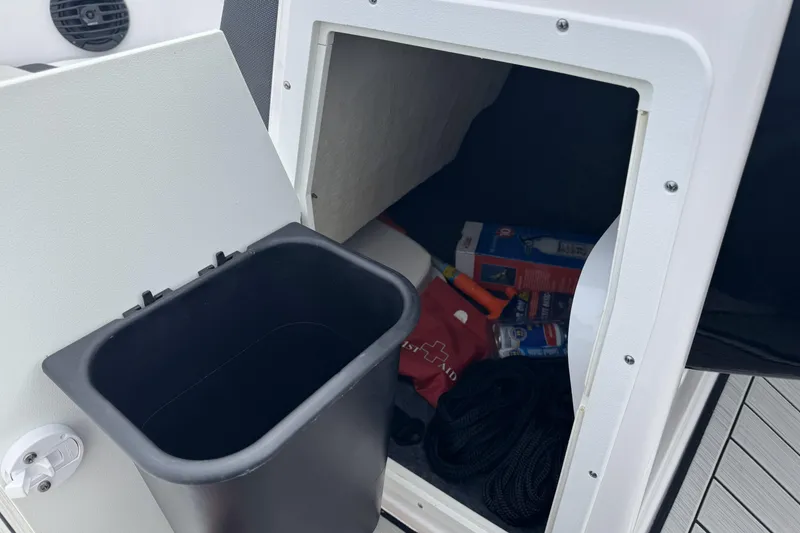 Slide: The Image of Storage compartment in 2024 Yamaha Boats 195S, featuring safety gear and accessories. - 18