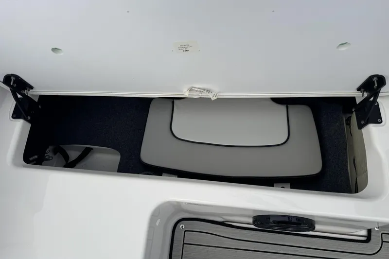 Slide: The Image of 2024 Yamaha Boats 195S storage compartment with cushioned interior and secure hinges. - 20