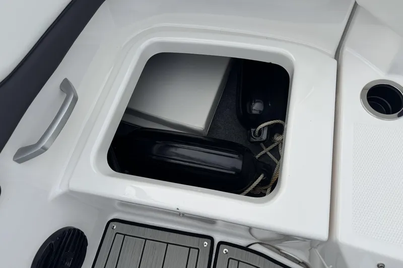 Slide: The Image of Storage compartment on 2024 Yamaha Boats 195S, featuring ropes and fenders. - 24