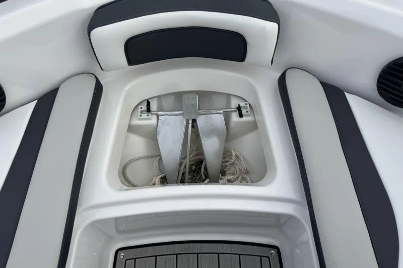 Slide: The Image of 2024 Yamaha Boats 195S anchor storage with rope, featuring cushioned seating. - 8