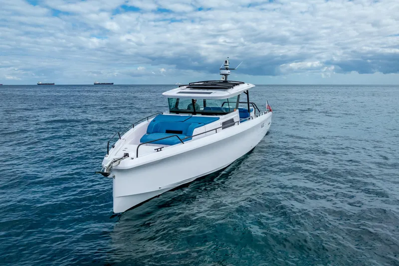 Slide: The Image of 2025 Axopar 45 Cross Top boat on open sea under cloudy sky. - 11