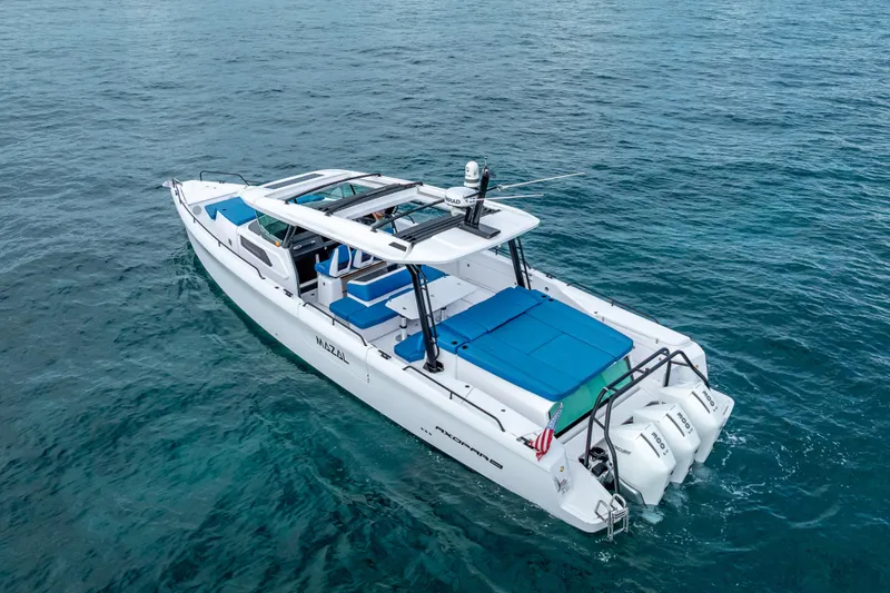 Slide: The Image of 2025 Axopar 45 Cross Top boat on clear blue water. - 12