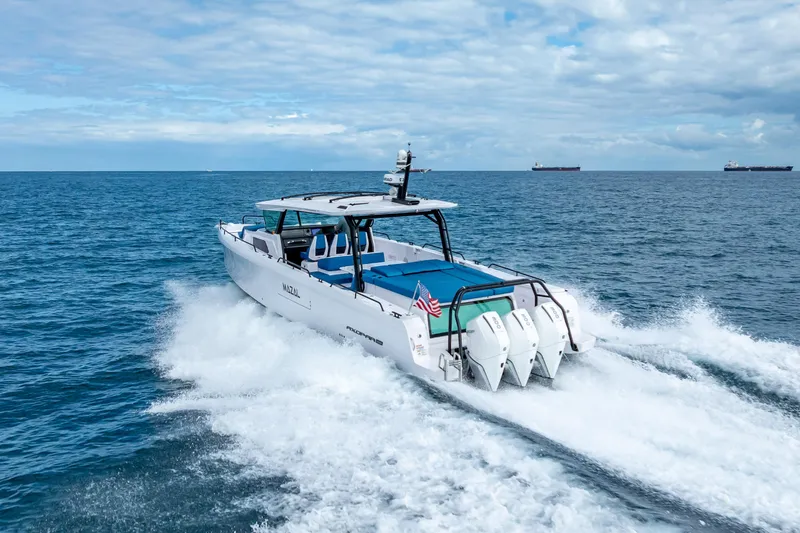 Slide: The Image of 2025 Axopar 45 Cross Top cruising on open sea with triple engines. - 13