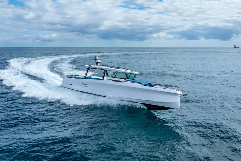 Slide: The Image of 2025 Axopar 45 Cross Top cruising on open sea under cloudy sky. - 19