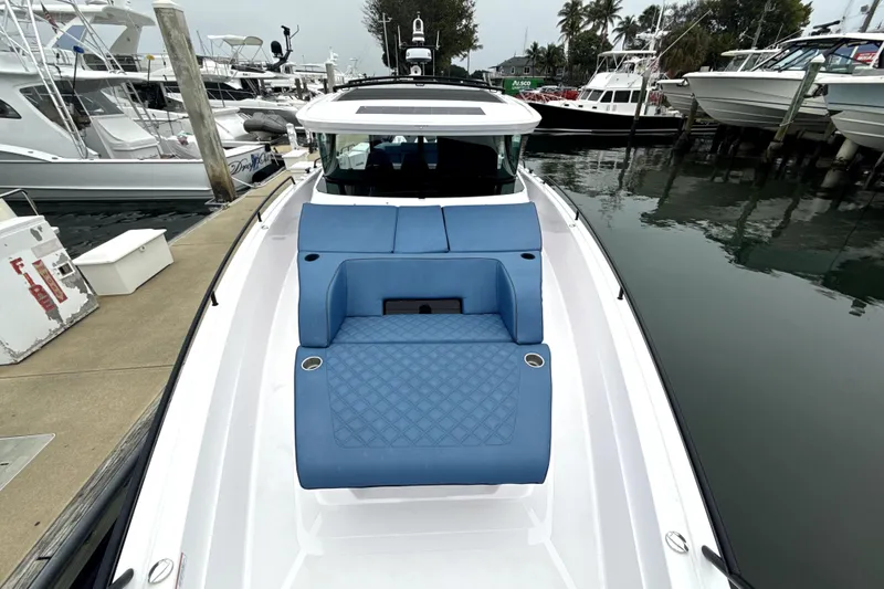 Slide: The Image of 2025 Axopar 45 Cross Top boat with triple engines on open water. - 2