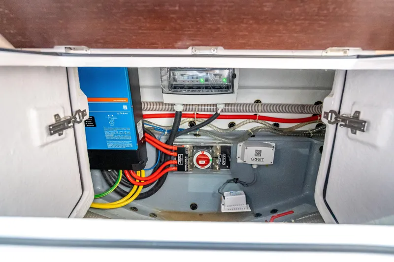 Slide: The Image of Electrical compartment of 2025 Axopar 45 Cross Top boat, featuring wiring and control systems. - 26