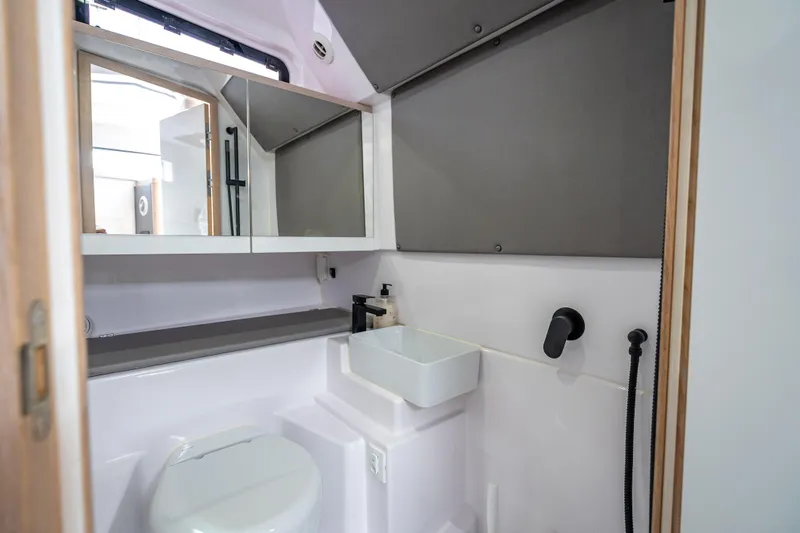 Slide: The Image of Modern bathroom interior of 2025 Axopar 45 Cross Top boat, featuring sleek fixtures and compact design. - 27