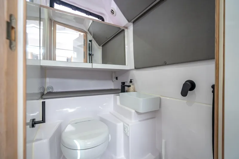Slide: The Image of Modern bathroom interior of 2025 Axopar 45 Cross Top boat, featuring sleek fixtures and minimalist design. - 28
