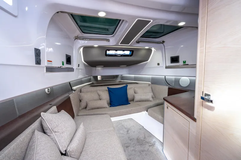 Slide: The Image of Luxurious interior of 2025 Axopar 45 Cross Top boat with modern seating and skylights. - 29