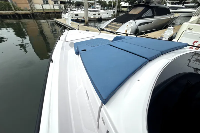 Slide: The Image of 2025 Axopar 45 Cross Top boat cruising on open water under a clear blue sky. - 3