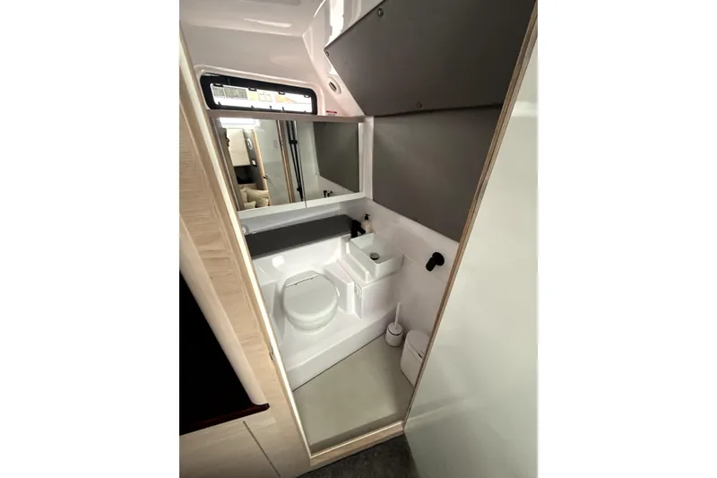 Slide: The Image of 2025 Axopar 45 Cross Top boat cruising on clear blue water. - 4