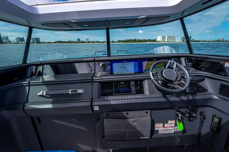 Slide: The Image of Helm of 2025 Axopar 45 Cross Top boat with modern navigation system. - 44