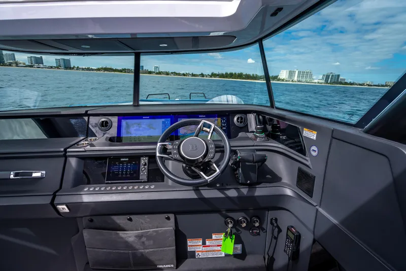 Slide: The Image of Interior view of 2025 Axopar 45 Cross Top boat cockpit with modern navigation system. - 45