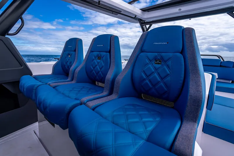 Slide: The Image of Luxurious blue seating on 2025 Axopar 45 Cross Top boat, ocean view. - 56