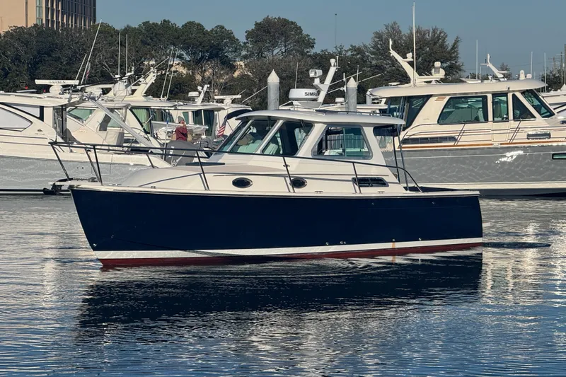 Slide: The Image of 2005 Back Cove 29 boat on calm water, surrounded by other vessels. - 0