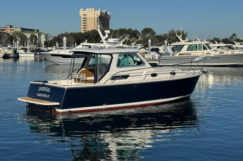 Slide: The Image of 2005 Back Cove 29 boat in marina, Charleston, SC, with clear blue sky. - 10
