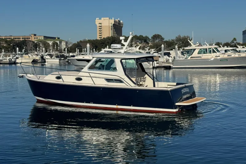Slide: The Image of 2005 Back Cove 29 boat on calm water, marina background. - 18