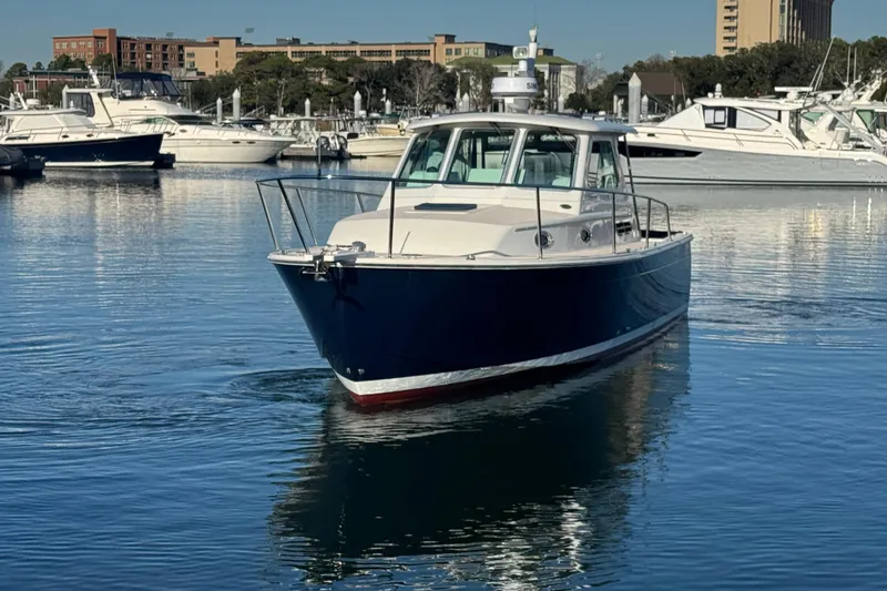 Slide: The Image of 2005 Back Cove 29 boat in marina, surrounded by other vessels. - 21