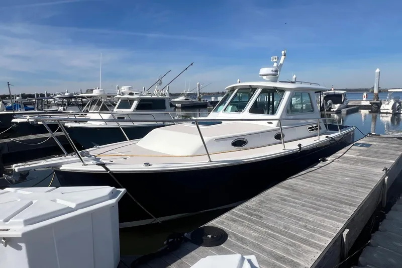 Slide: The Image of 2005 Back Cove 29 boat docked at marina under clear blue sky. - 25