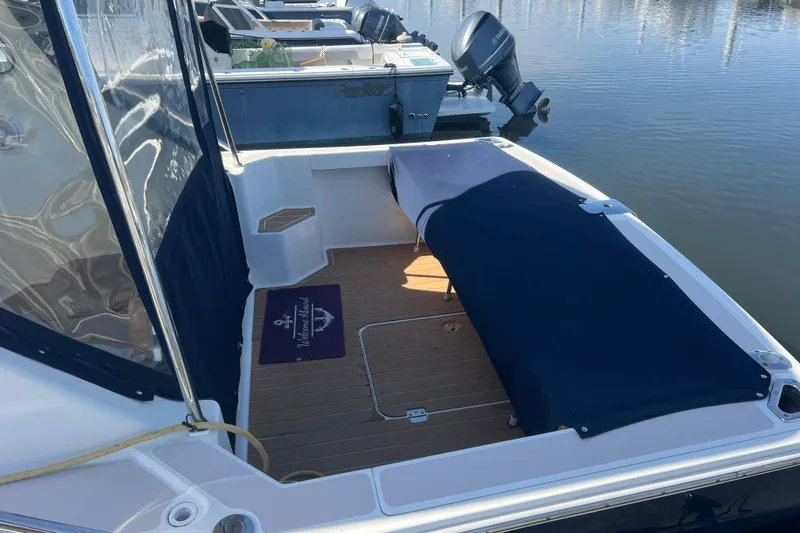 Slide: The Image of 2005 Back Cove 29 boat with covered seating area, docked at marina. - 27