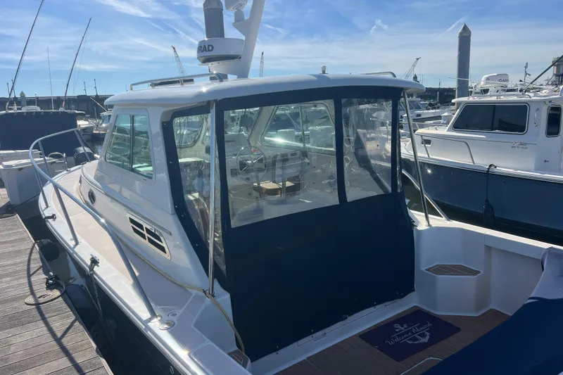 Slide: The Image of 2005 Back Cove 29 boat docked at marina under clear blue sky. - 29