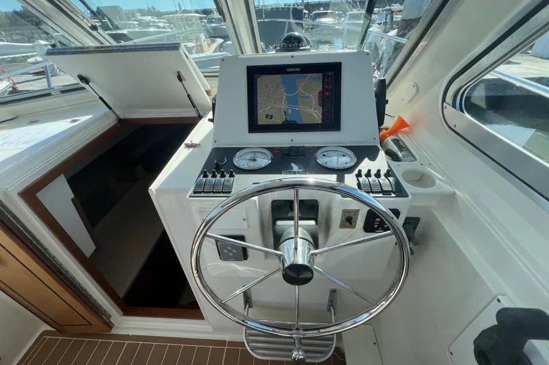 Slide: The Image of 2005 Back Cove 29 boat helm with navigation system and steering wheel. - 34