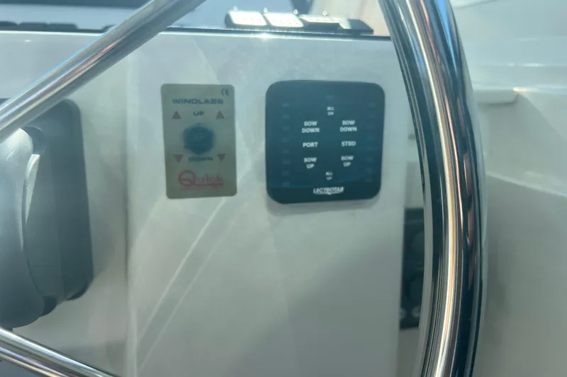 Slide: The Image of Control panel of a 2005 Back Cove 29 boat with steering wheel. - 37