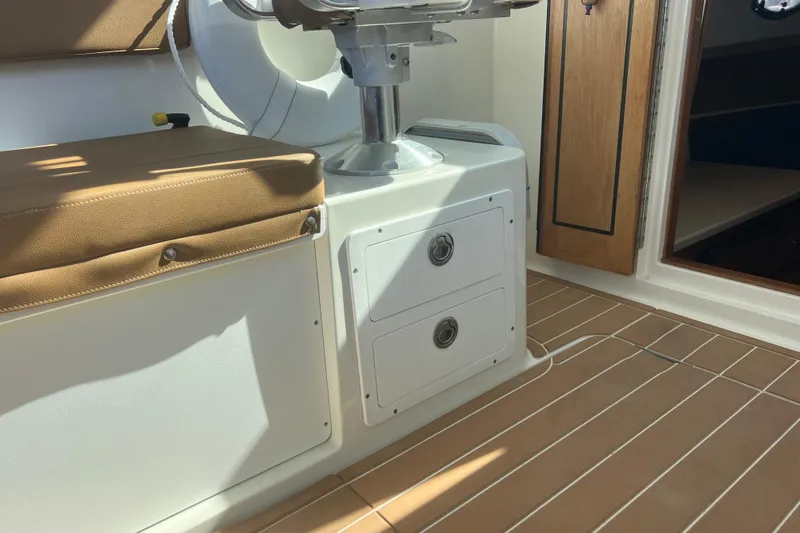 Slide: The Image of 2005 Back Cove 29 interior with cushioned seating and storage drawers. - 41