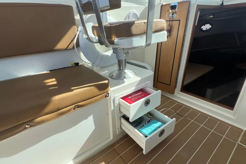 Slide: The Image of Interior of 2005 Back Cove 29 boat with open storage drawers and seating. - 42