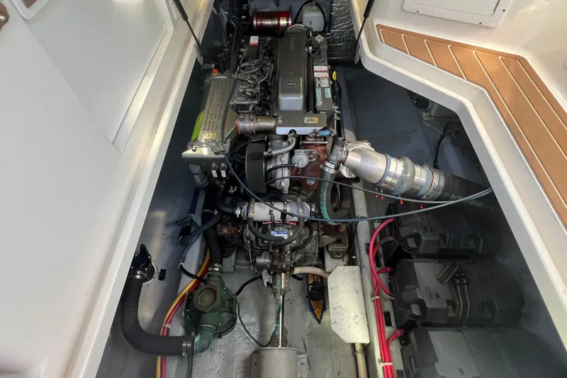 Slide: The Image of Engine compartment of a 2005 Back Cove 29 boat, showcasing detailed mechanical components. - 57