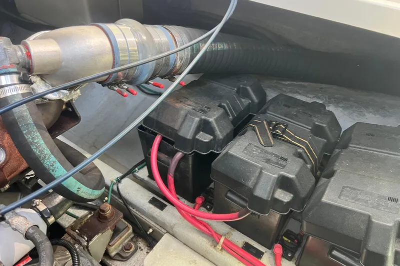 Slide: The Image of Engine compartment of a 2005 Back Cove 29 boat with battery boxes and wiring. - 58