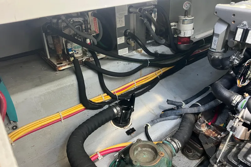 Slide: The Image of Engine compartment of a 2005 Back Cove 29 boat, showing hoses and wiring. - 59