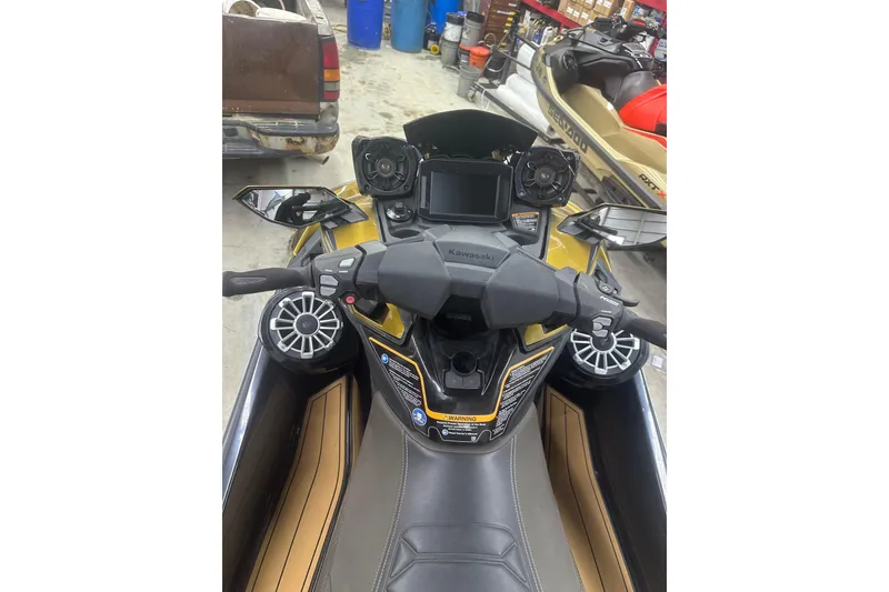 Slide: The Image of 2023 Kawasaki Jetski Ultra 310LX dashboard with controls and speakers in a garage setting. - 12